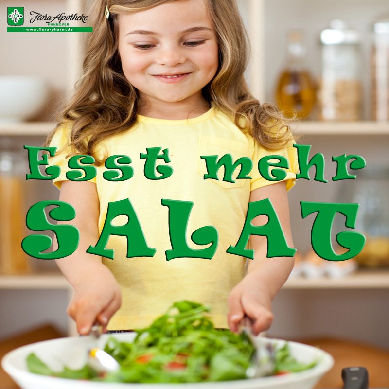 Cute little girl preparing salad herself